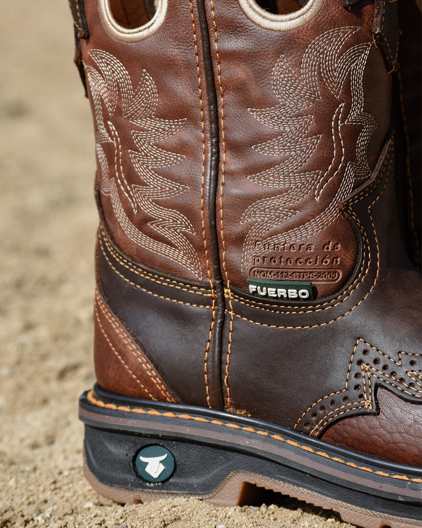 Close-up of the Fuerbo 5038 brown leather shaft, decorative western stitching, reinforced panels, welt, and branded heel.
